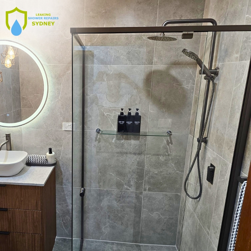 A bathroom featuring a shower and sink, highlighting areas for leaking shower repairs in Abbotsbury.