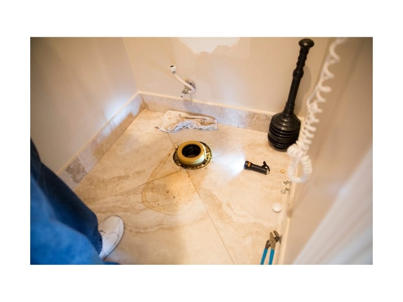 A close-up of a dirty bathroom tile, highlighting the need for replacing tiles in bathroom due to wear.