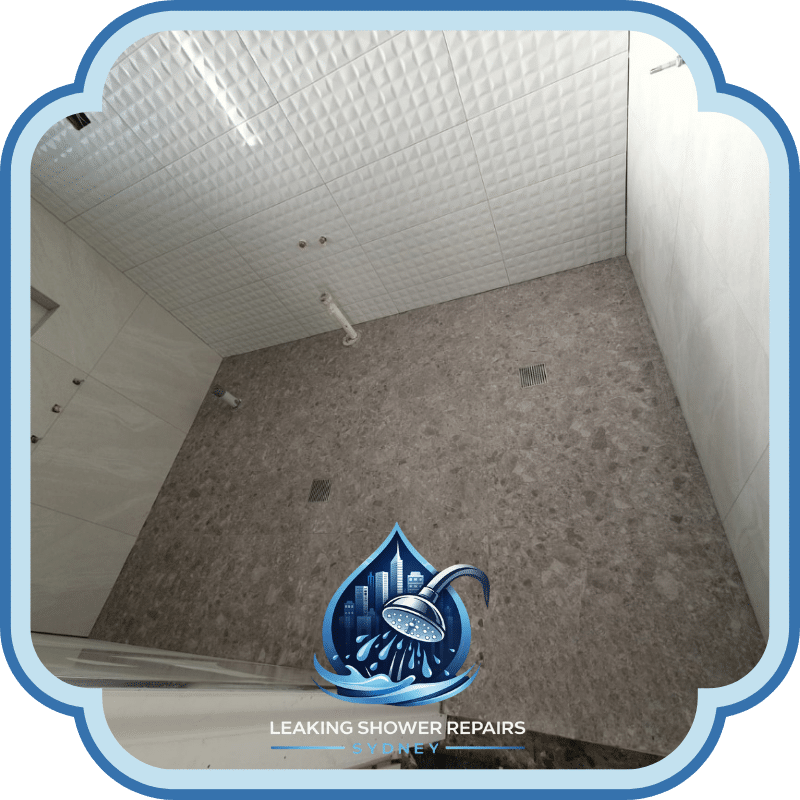 Bathroom floor and wall tiles fully installed with floor drains visible, showcasing completed Bathroom Tiling Services in a modern shower area.