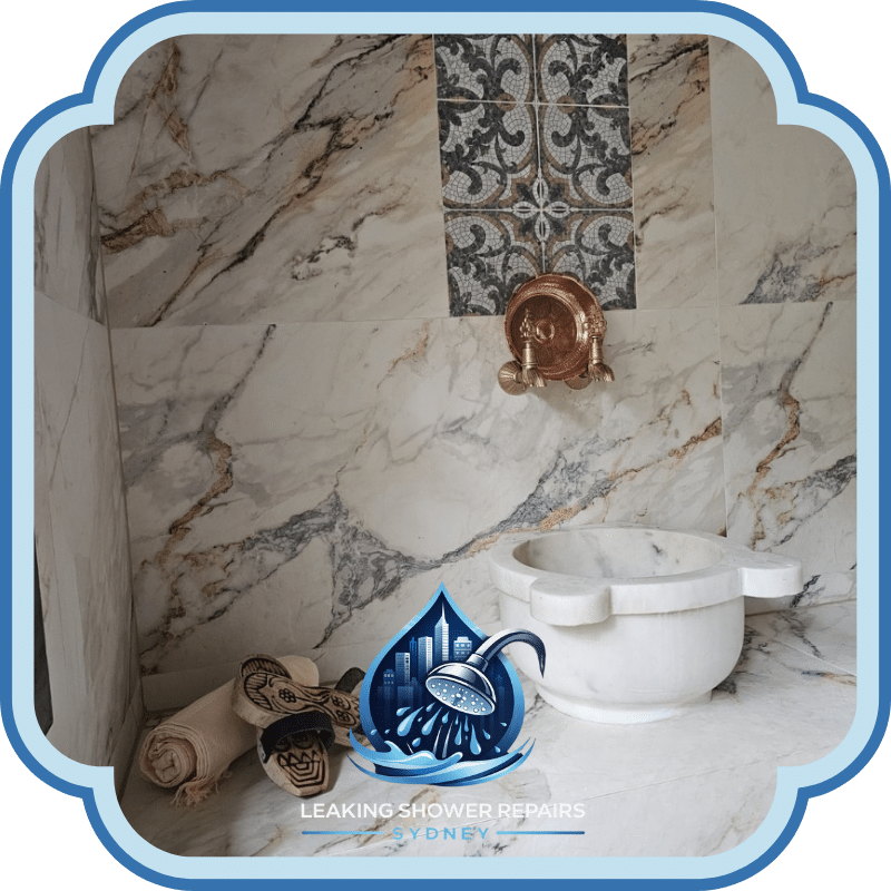 Bathroom Makeovers Services featuring a luxury marble bathroom niche with decorative tiles, wall tapware, stone basin, towels and accessories.