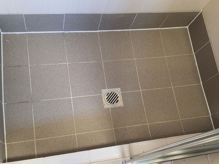 Technician resealing a shower in Camden without removing tiles
