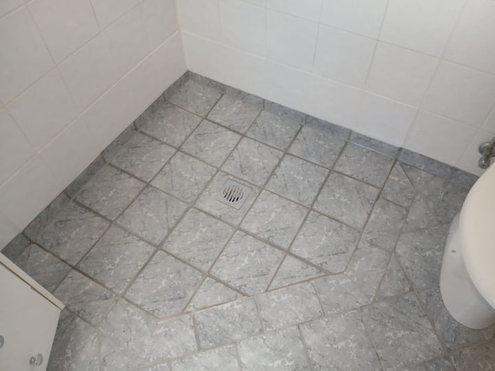 Technician resealing a shower in Hornsby without removing tiles