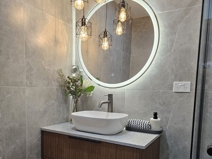 Technician resealing a shower in Liverpool without removing tiles