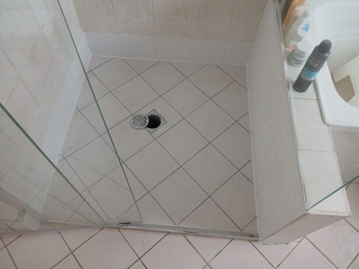 Technician resealing a shower in Strathfield without removing tiles
