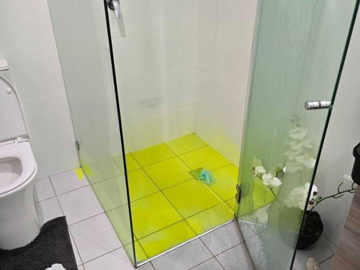 Technician resealing a shower in Sutherland Shire without removing tiles